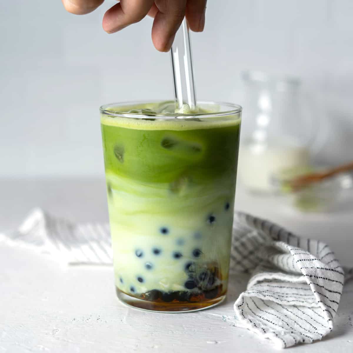 https://www.elmundoeats.com/wp-content/uploads/2022/07/RC-Stirring-a-glass-of-matcha-milk-tea.jpg
