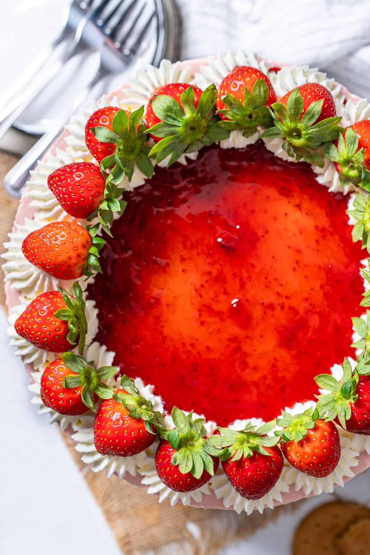 Creamy strawberry cheesecake on a cake stand view from up.