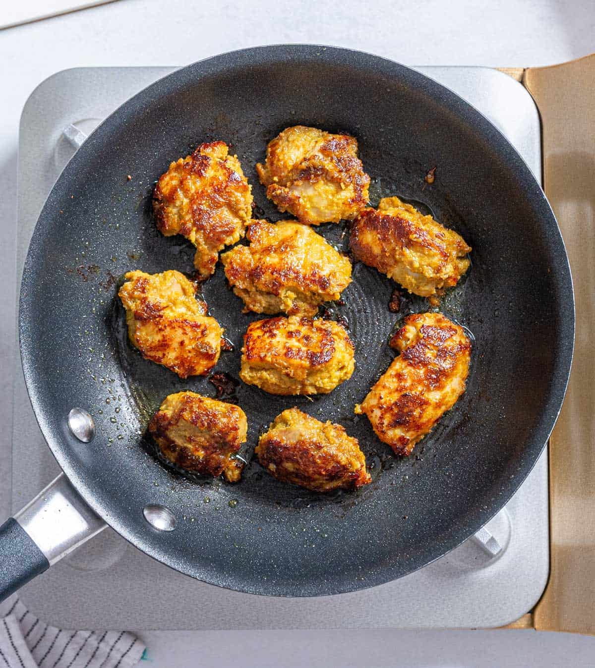 Cooking satay in a pan.