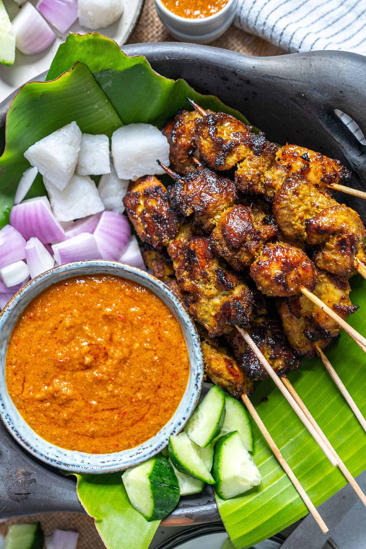 Malaysian chicken satay served with satay sauce and condiments.