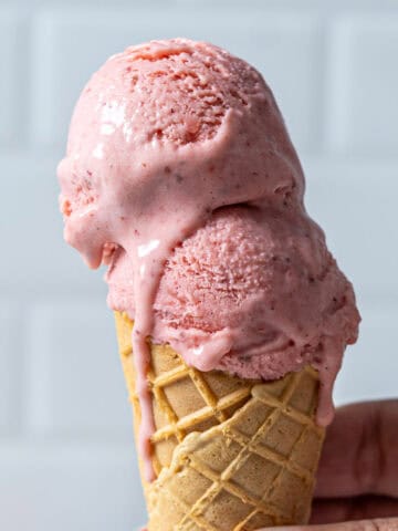 Strawberry ice cream in a cone.