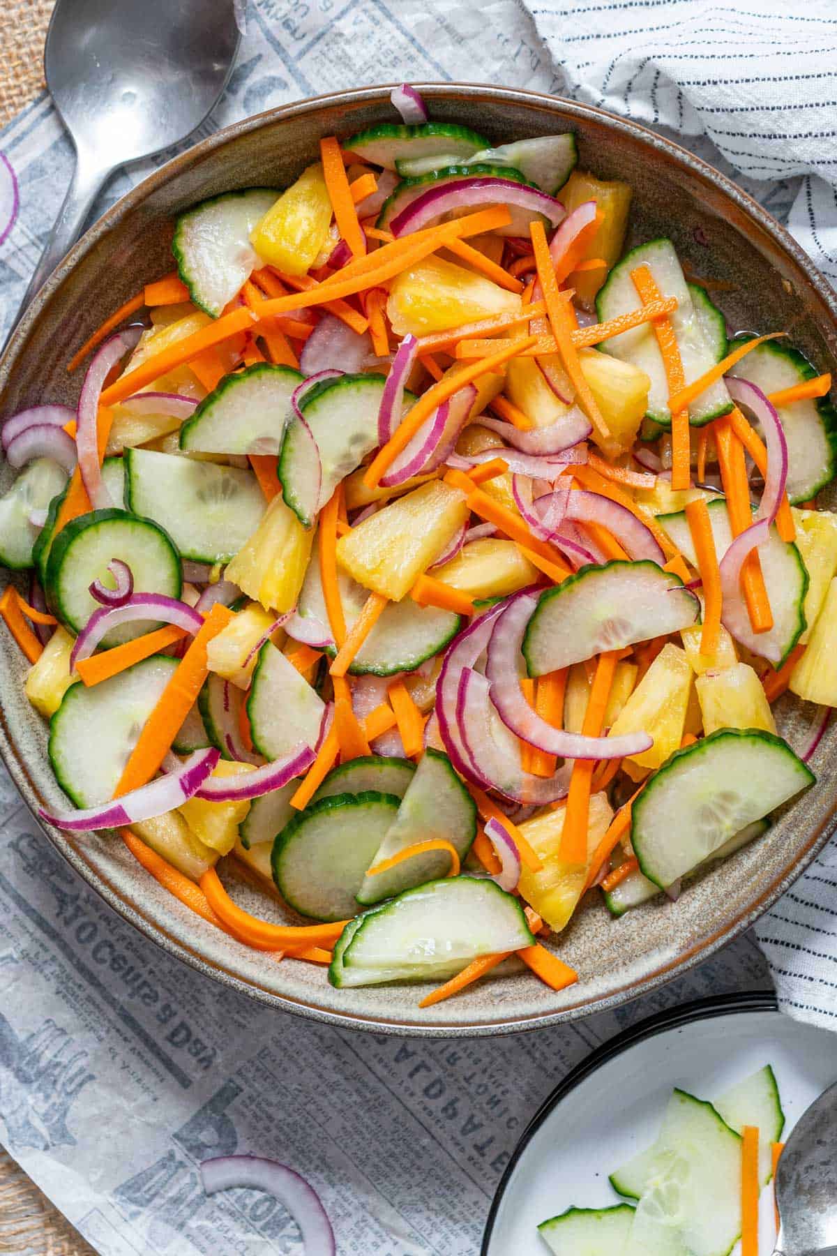 Asian cucumber and pineapple salad in a serving plate.