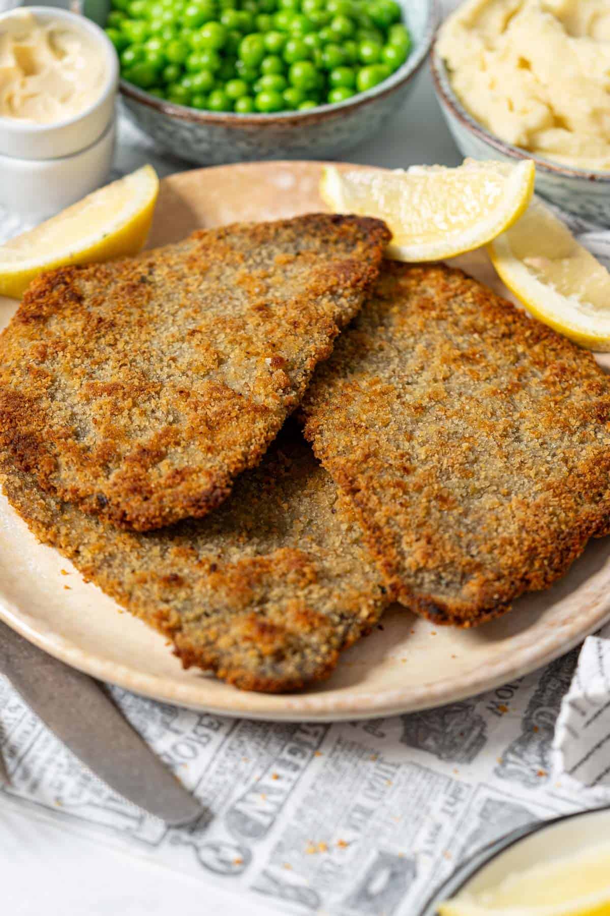 Milanesa steaks on a plate.