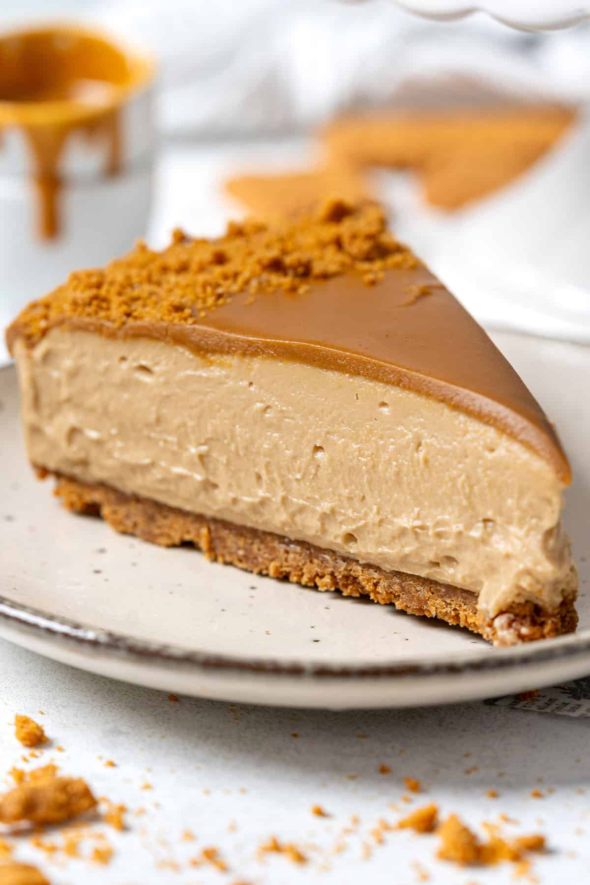 A slice of Biscoff cheesecake in a plate.